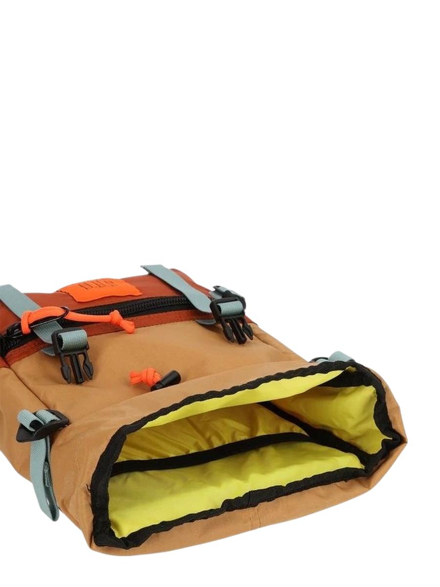 A Rover Pack Mini Backpack with orange and brown colors, featuring multiple compartments, padded shoulder straps, and a top carry handle, showcasing its insides.