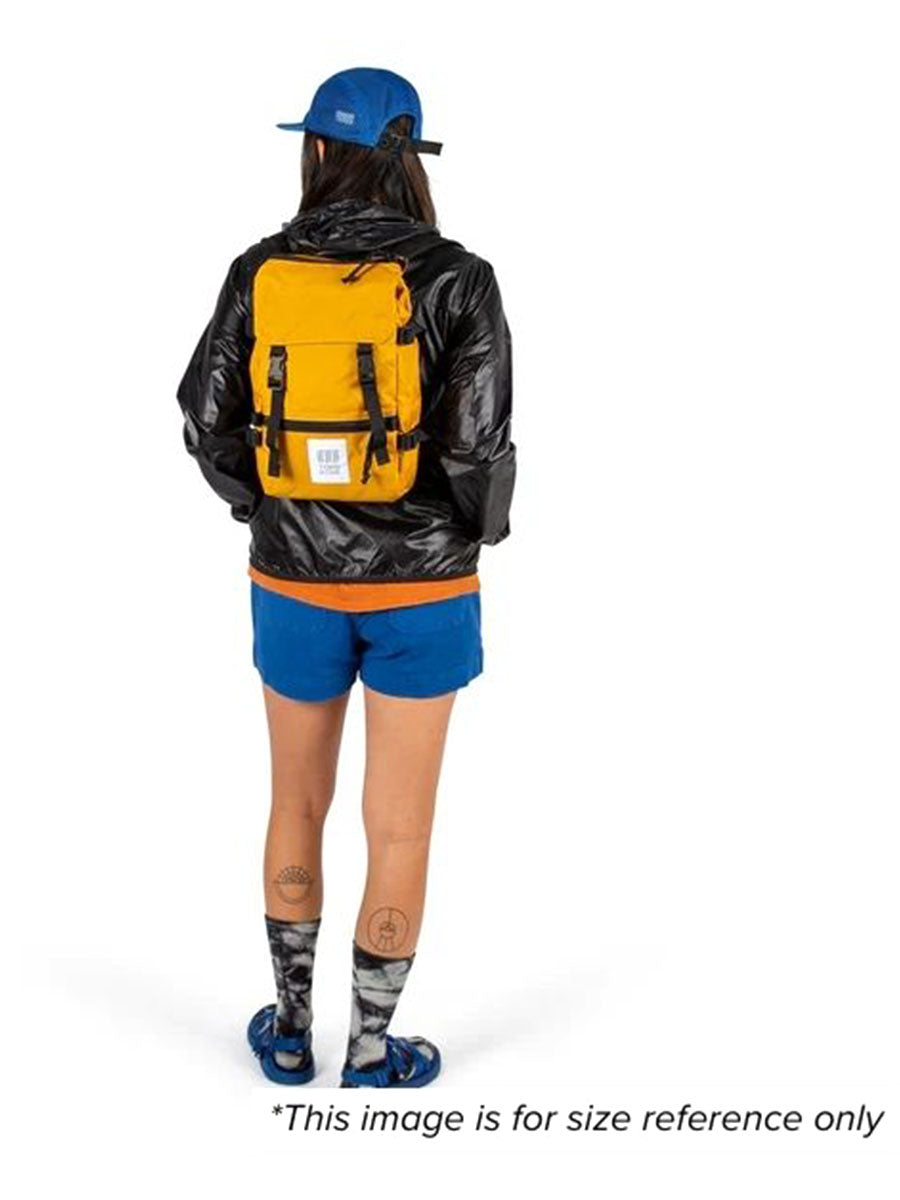 A woman showcasing a mini backpack for size for size reference.