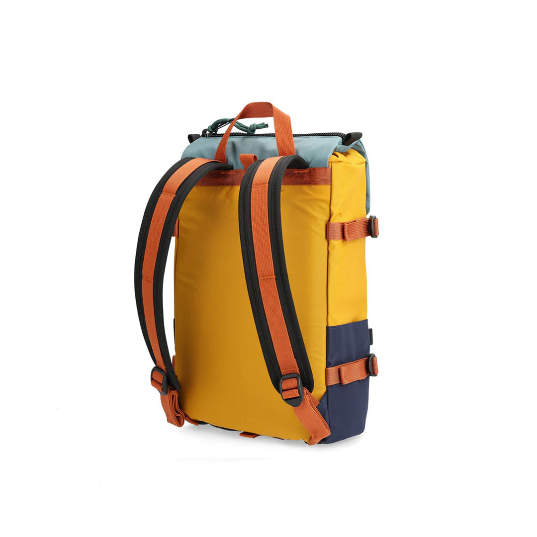 A backside view of a Rover Pack Mini Backpack with top handle, featuring a combination of blue, yellow, and navy colors with orange straps and buckles.