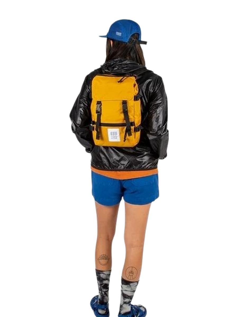 A woman showcasing a mini backpack for size for size reference.