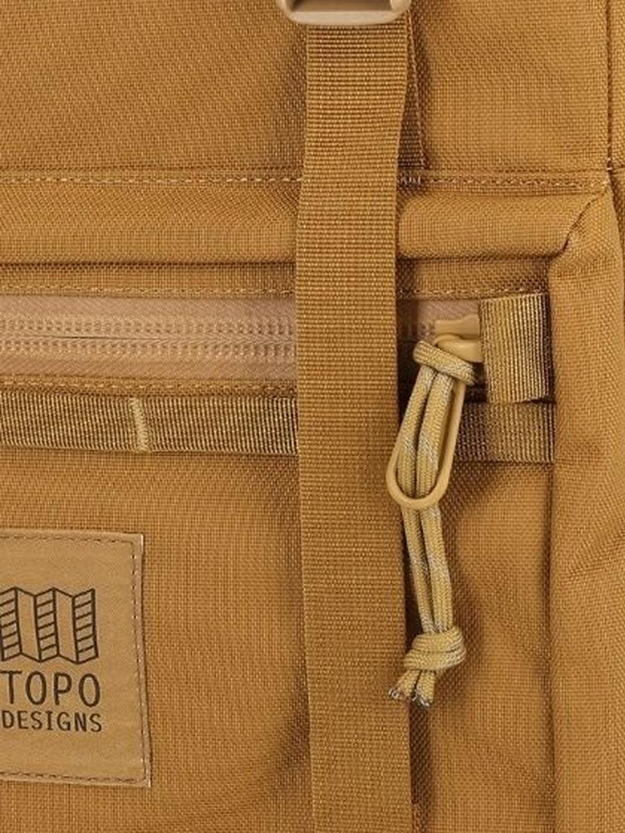 A closeup view of the brown Rover Pack Tech Backpack