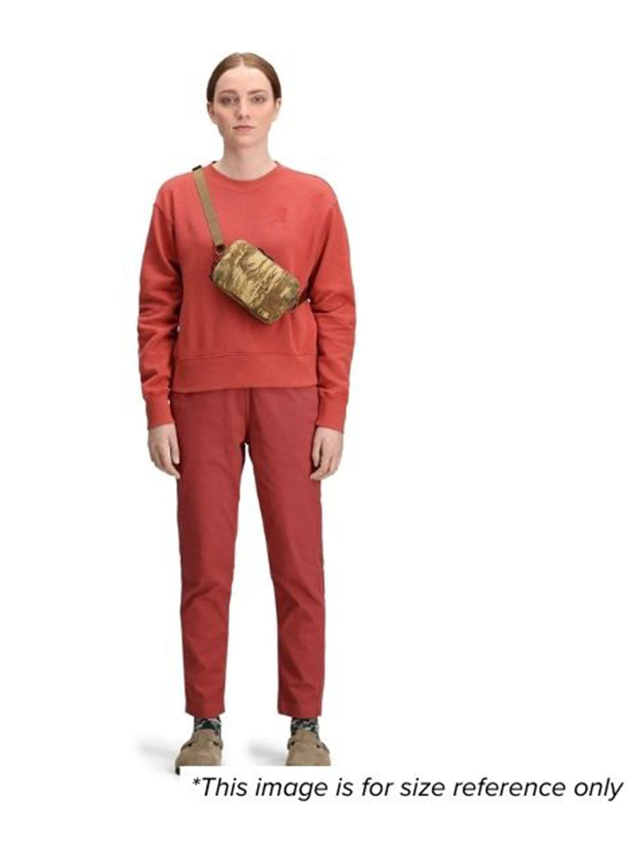 A woman wearing a brown shoulder bag for size reference