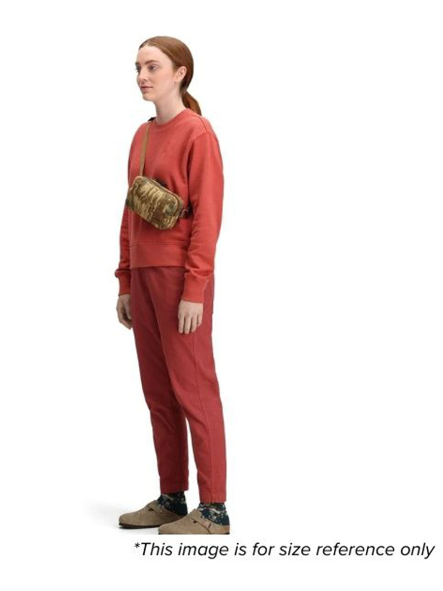 A woman wearing a brown shoulder bag for size reference.