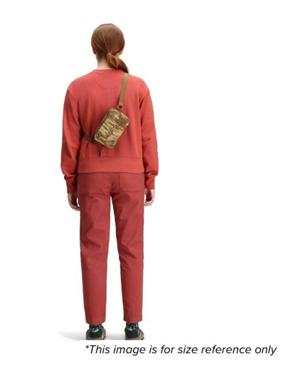 A woman showing her back wearing the bag for size reference.