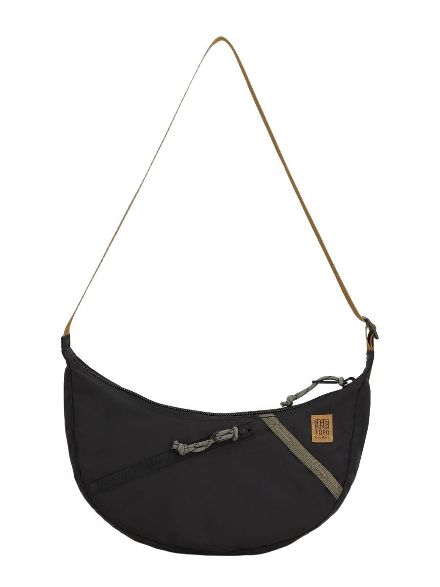 A black Moonlight Crossbody Bag with an adjustable shoulder strap and a front zippered pocket.
