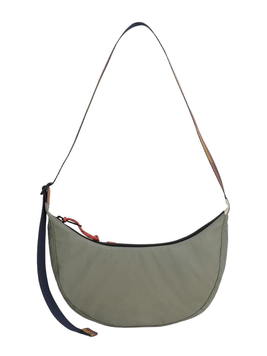 A backside view of a Moonlight Crossbody Bag with a geometric pattern in multicolor, featuring an adjustable shoulder strap, front zippered pocket, and a small, compact design.