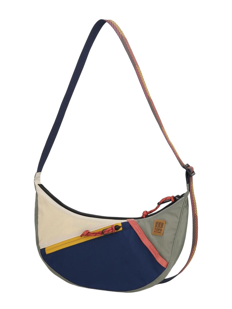 A Moonlight Crossbody Bag with a geometric pattern in multicolor, featuring an adjustable shoulder strap, front zippered pocket, and a small, compact design.