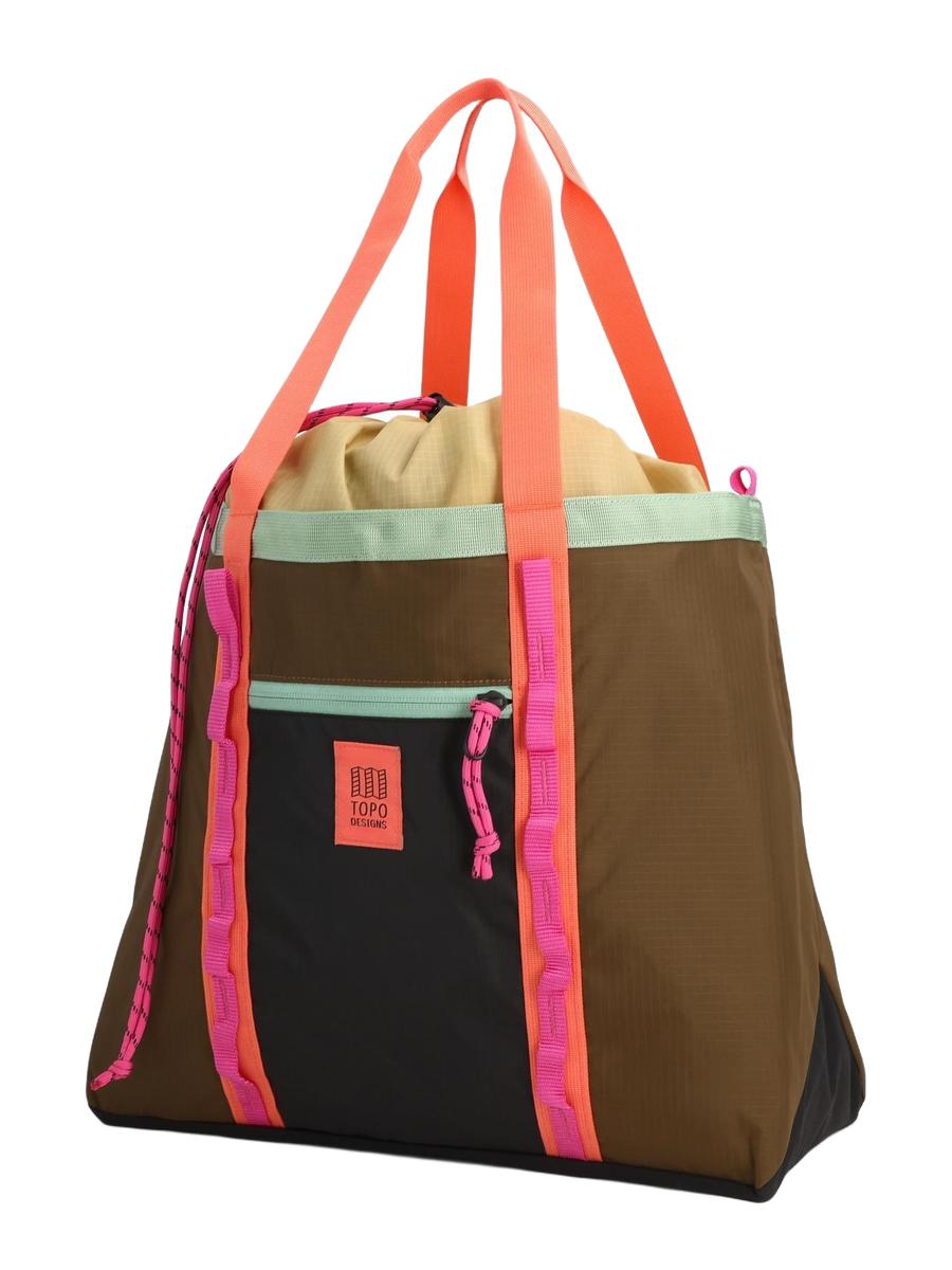 A multicolored Mountain Utility Tote Shoulder Bag with a brown base, and pinkish accents and a black adjustable padded shoulder strap.