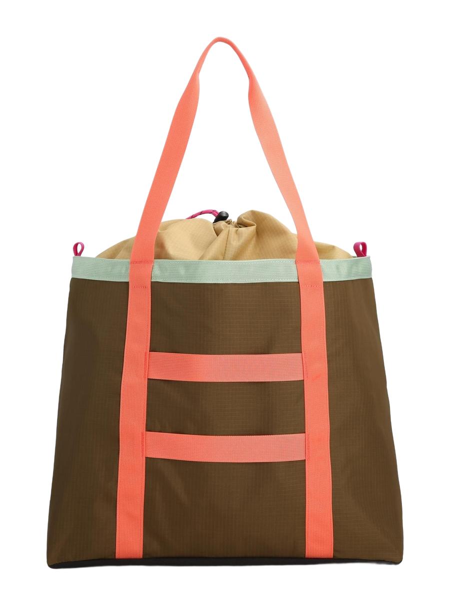 A backside view of a multicolored Mountain Utility Tote Shoulder Bag with a brown base, and pinkish accents and a black adjustable padded shoulder strap.