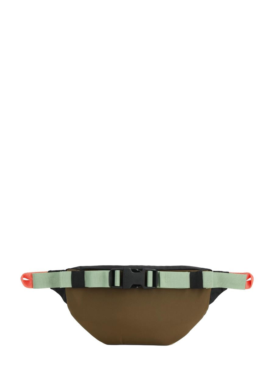 A backside view of the beige Mountain Waist Pack with pink and black trim, featuring two pockets and heavy duty zippers, seated against a white background.