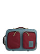 A gray and red briefcase backpack with an external laptop compartment and mesh pockets, with the TOPO Designs logo visible.
